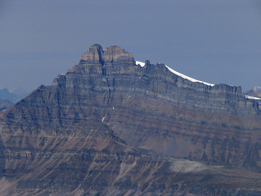Snoopy sleeping on his dog house.