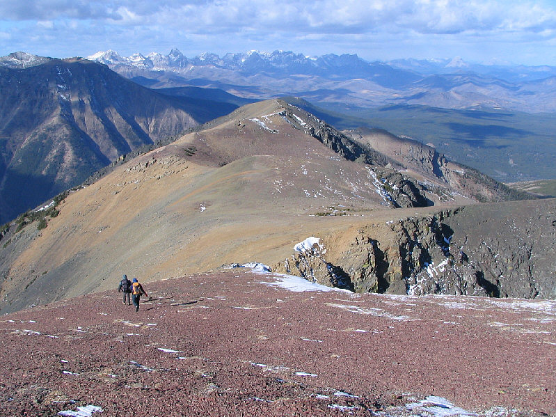 There aren't any easy shortcuts down the east side of the ridge.  It's best to head back over Southfork Mountain.