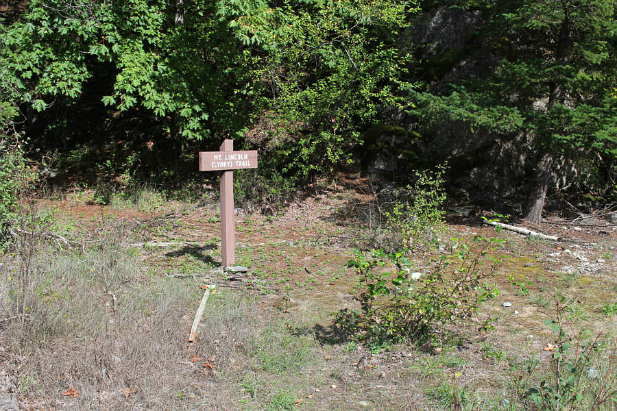 Actually, the sign is a bit confusing. Don't go behind it; head right and follow the white log on the ground.