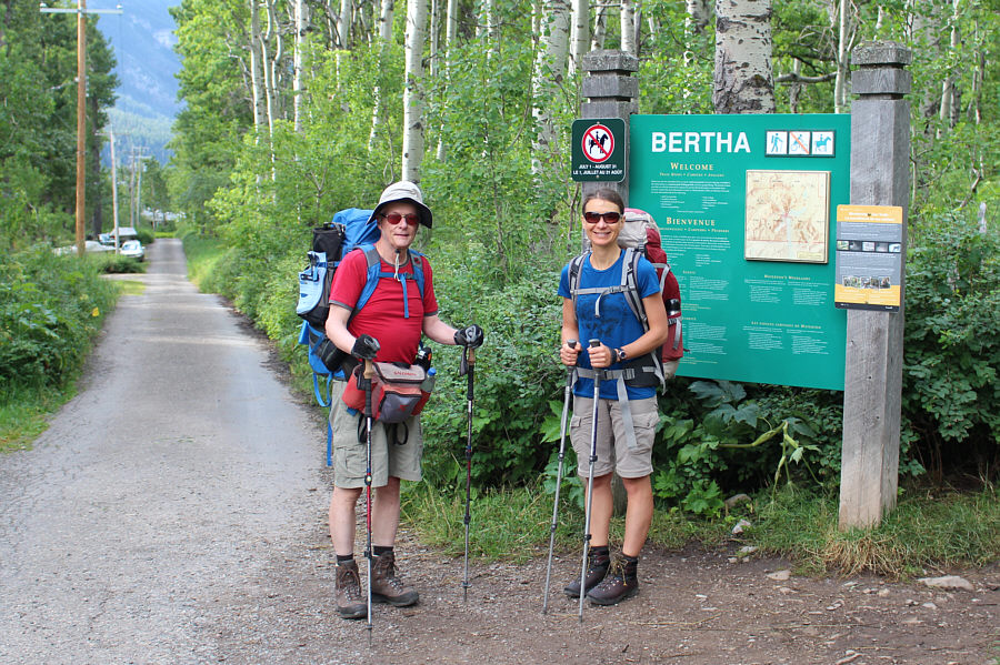 The trail goes into the trees at right and not the back alley!