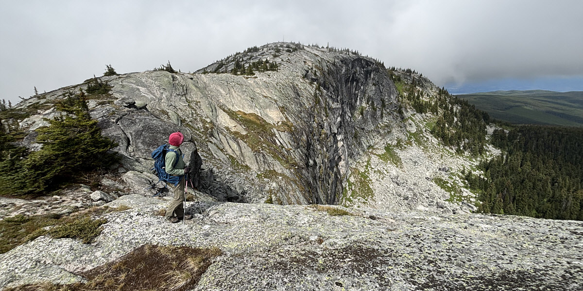Go to the edge to see a hidden pond below the cliffs.